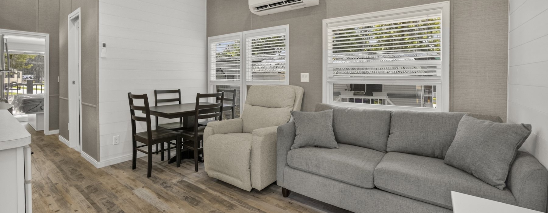 a living room with a couch, table and chairs